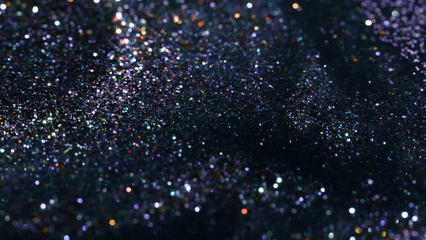 Sparkly shards flow and wave in a pile