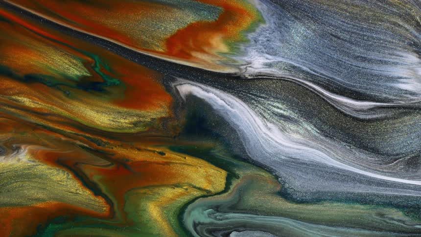 Glittery paint flows and swirls