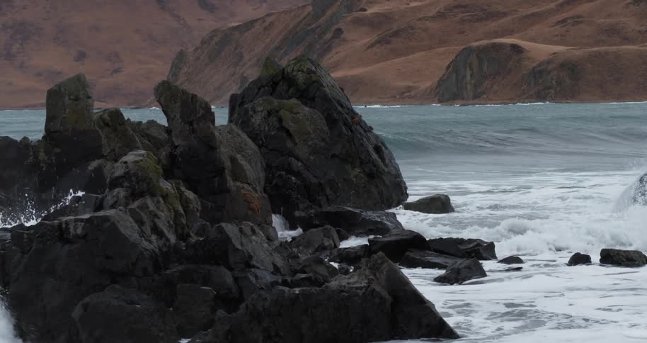Ocean waves crash into rocks