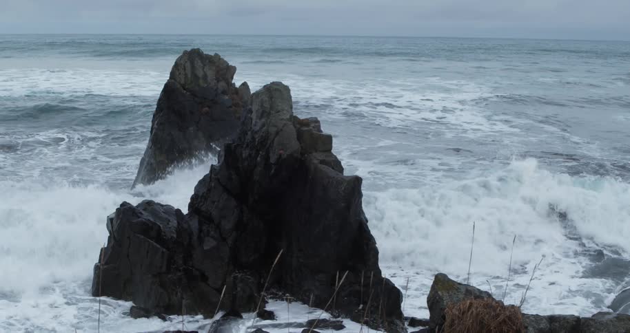 Ocean waves crash into rocks
