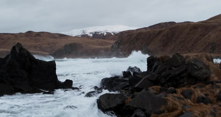 Ocean waves crash into rocks