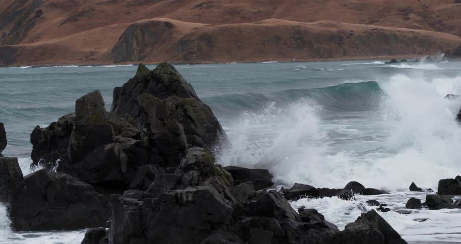 Ocean waves crash into rocks