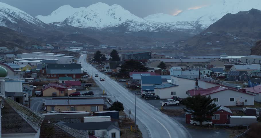 Cars drive through a mountain town