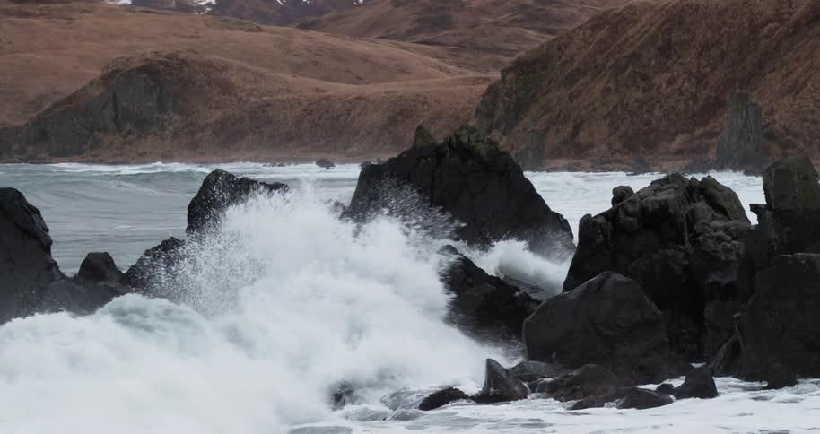Ocean waves crash into rocks
