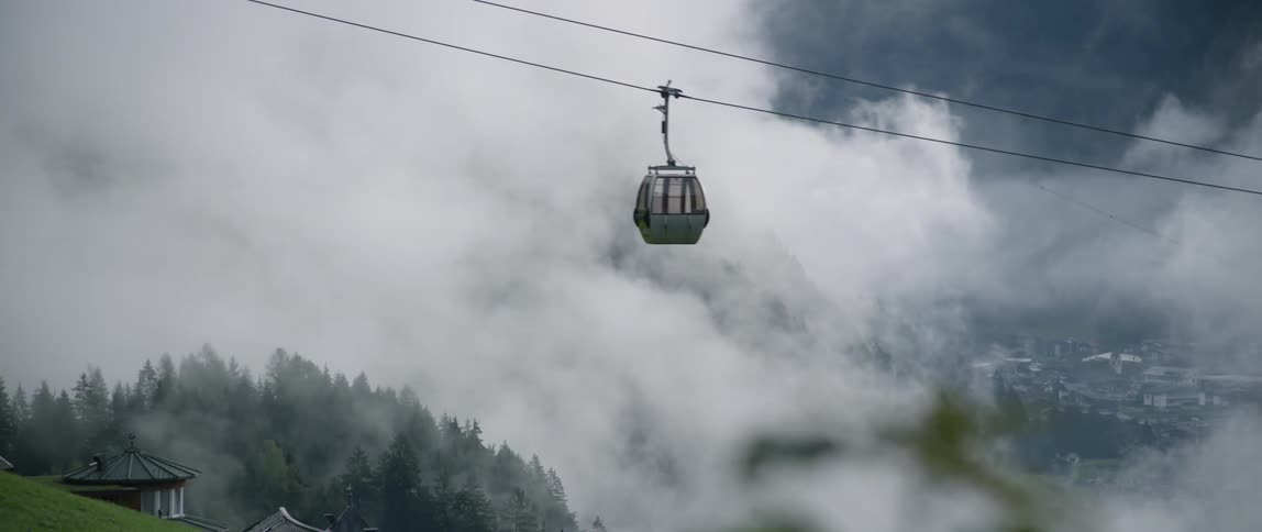 A ski lift ascends up the cable track