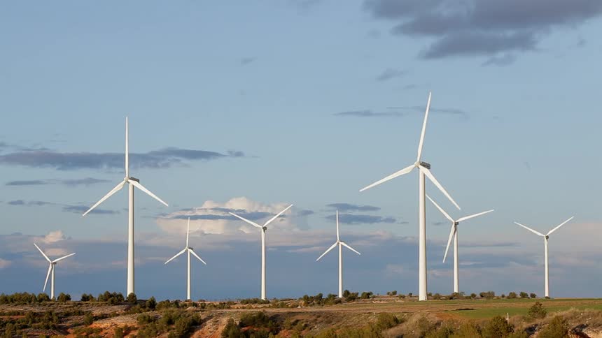 Windmills are spinning on a plateau during the day