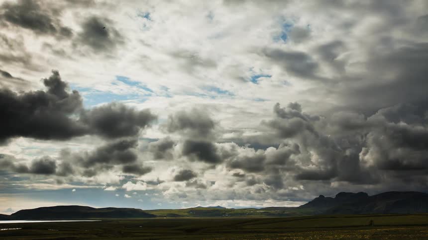 Clouds float over a mountain valley
