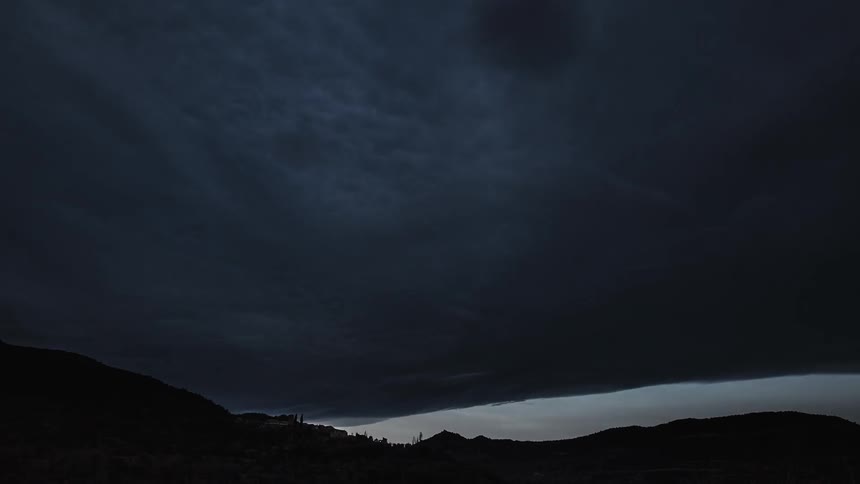 Storm clouds float in the sky at sunset