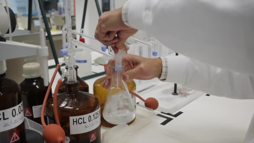 A chemist mixes liquids