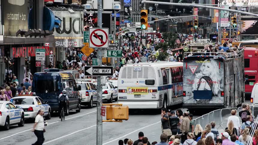 Time-lapse of people and traffic moving through a large city