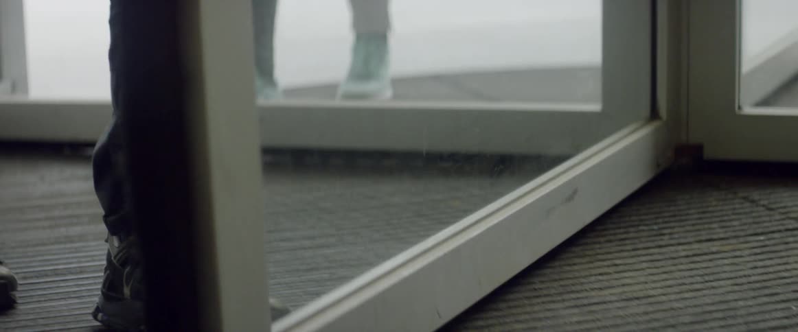 People enter a building through a rotating door