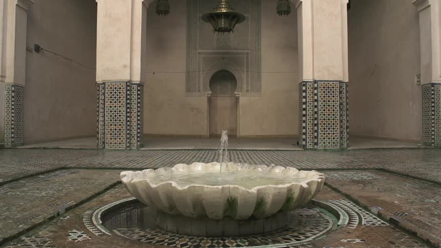 A fountain shoots water in a courtyard