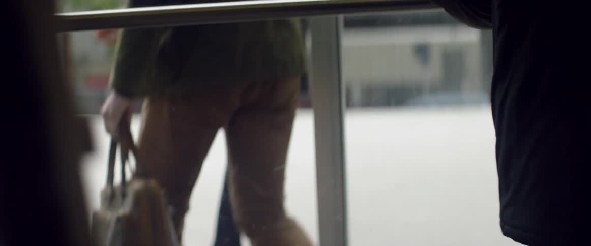 People are walking out of a building through revolving doors
