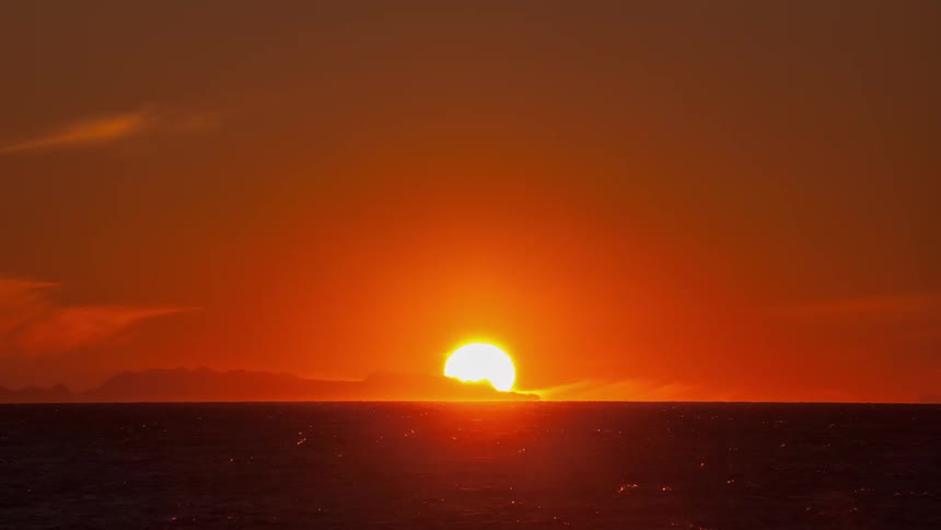 The sun sets over an ocean