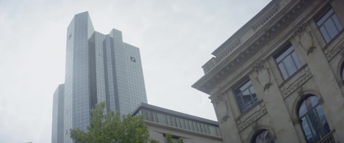 Clouds are hovering in the sky above a skyscraper during the day