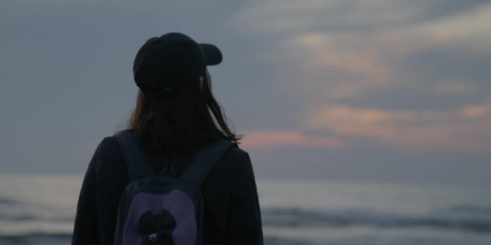 Person looks out at a body of water
