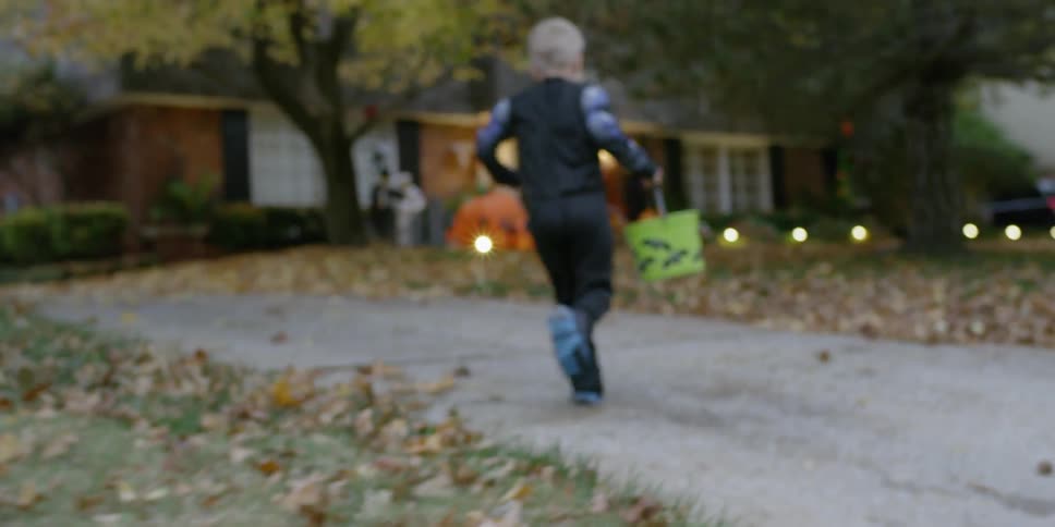 Children run while trick or treating
