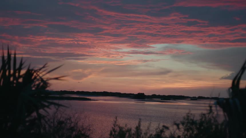 Clouds float over a lake at sunset