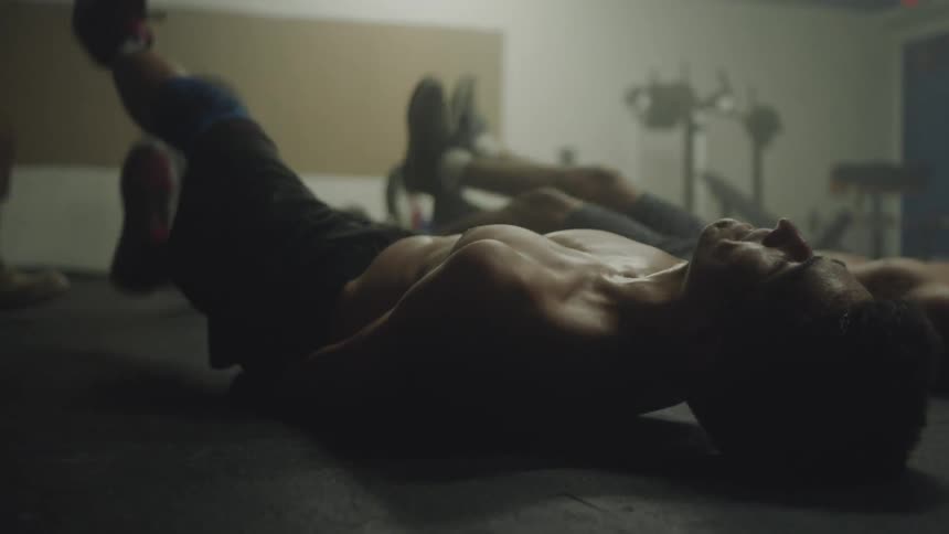 Men on their back kicking their legs up for exercise