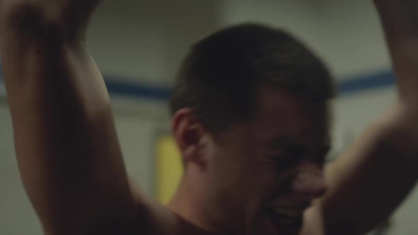 Man lifting a weight up and down above his head