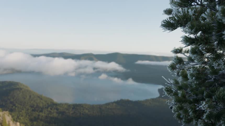 Clouds float over a lake and hills