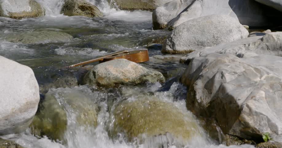 A guitar floats down a river