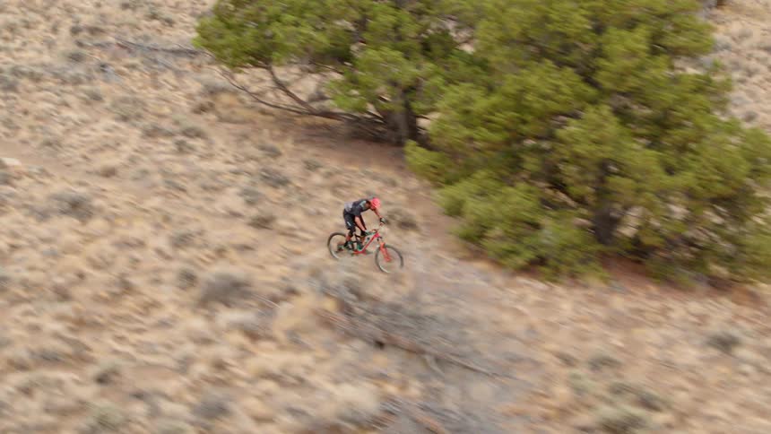 A person rides a mountain bike on a dirt trail
