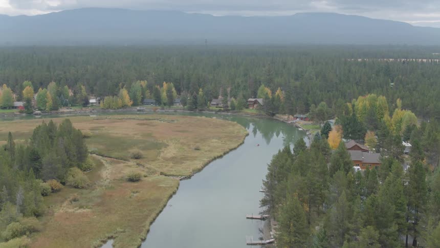 A kayak is floating down a river during the day