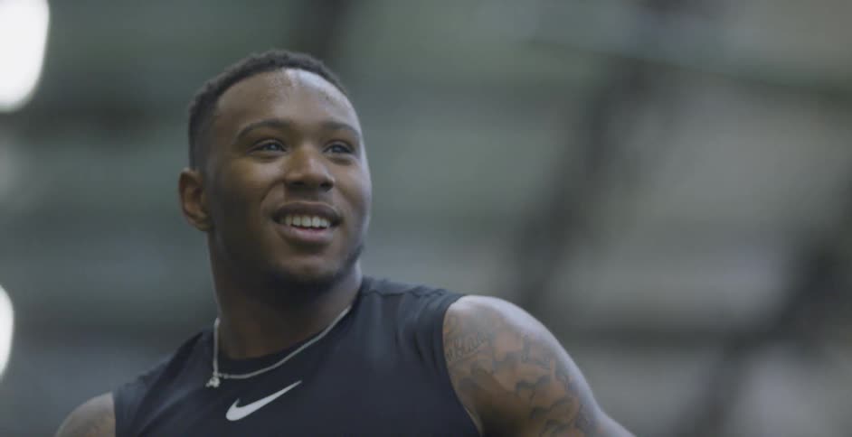 A football player smiles while training