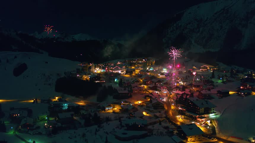 Fireworks explode over a mountain village