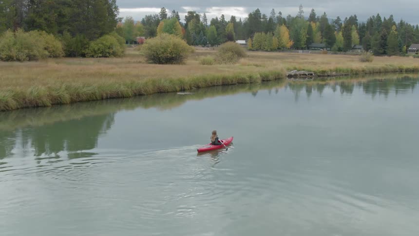 A woman kayaks on the water