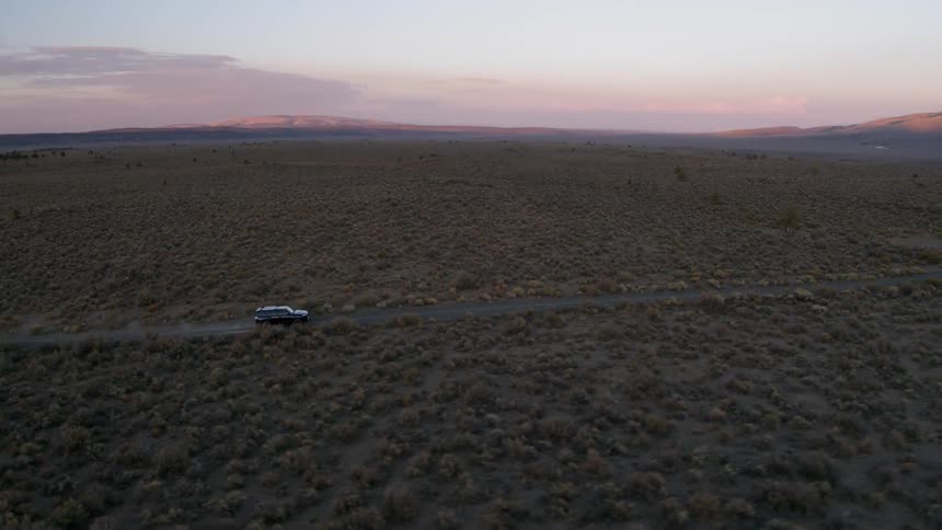 A wagon is driven through the plains