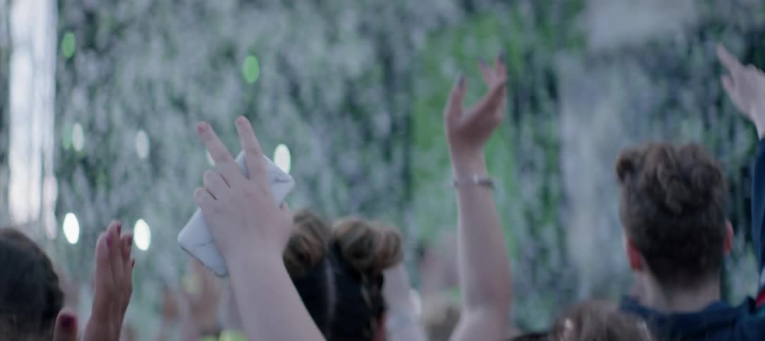 Confetti flies around a concert crowd