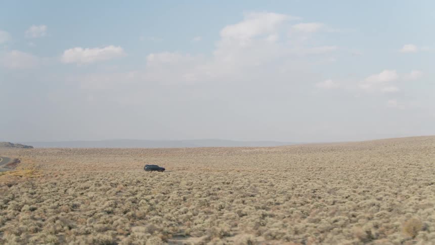 Jeep drives on a country road and turns onto a bumpy small road