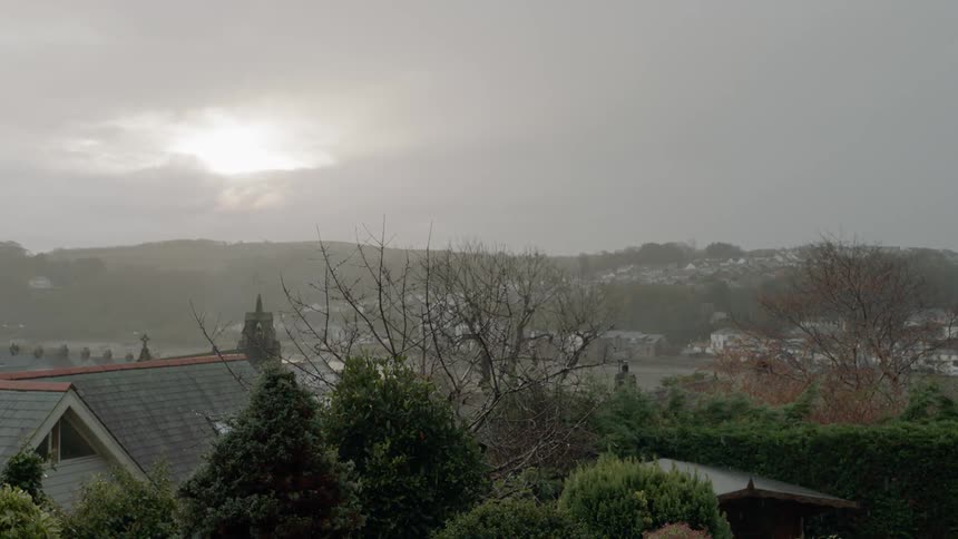 Rain falls in a neighborhood