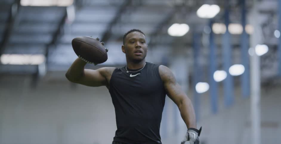 A man grips a football and tosses it