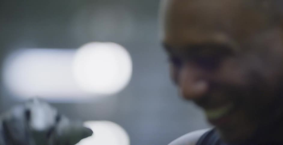 A football player smiles while training