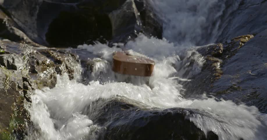 Guitar crashes down river rapids over the rocks