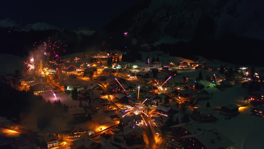 Fireworks explode above a town