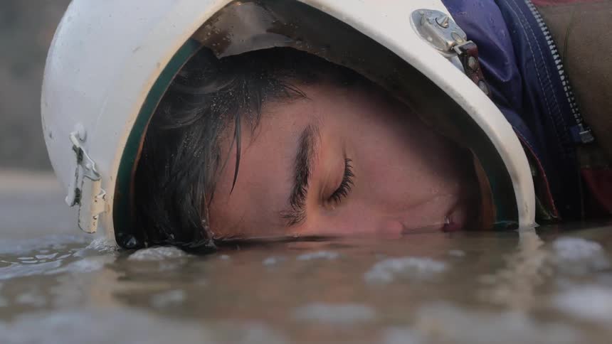 A person laying face down in water