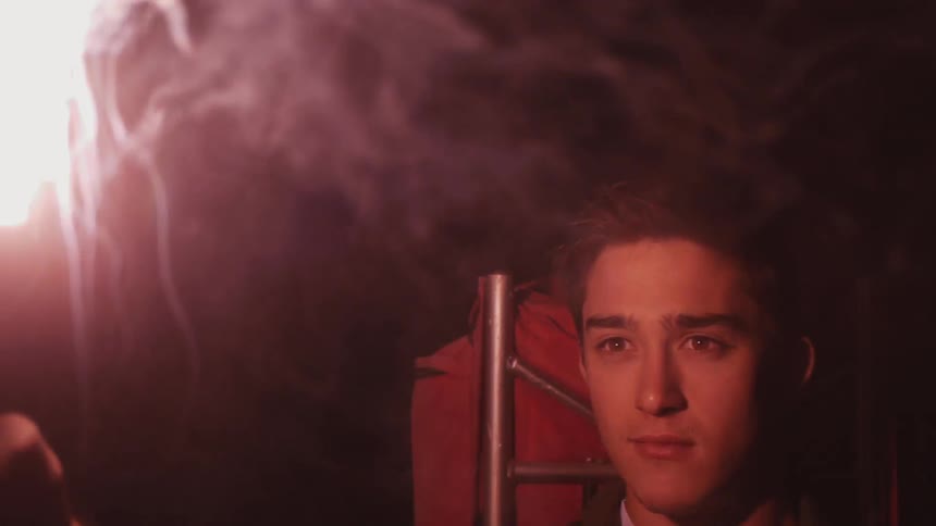 Man lighting off a flare in a dark area