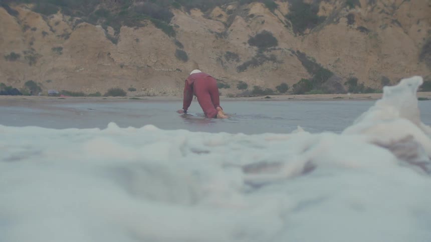A person laying face down in water