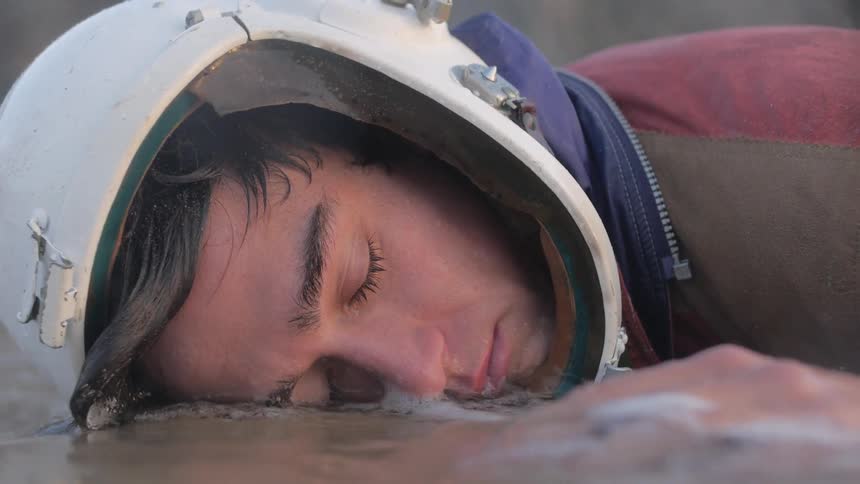 A man is sleeping in the water
