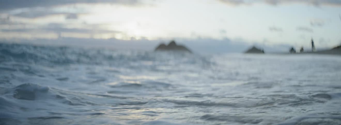 Waters coming ashore on a cloudy sunset evening