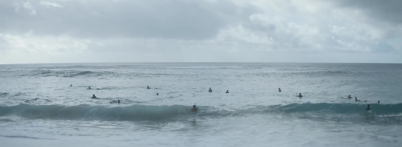 Beachgoers swim in the ocean