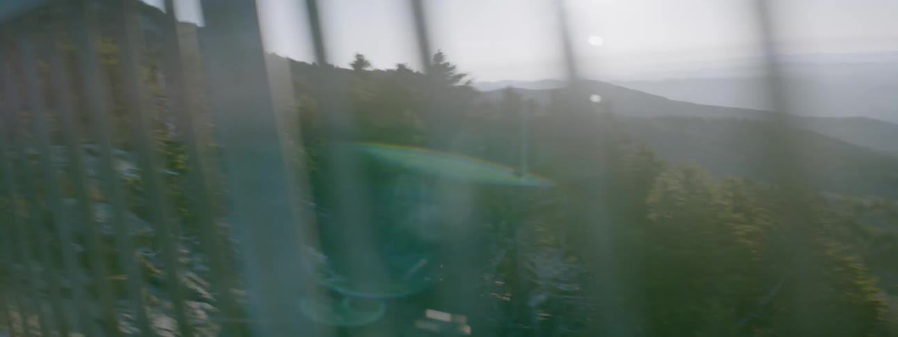 A car drives in the mountains on a sunny day