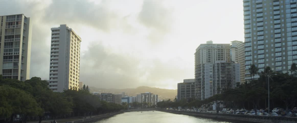 A river flows in between the buildings of a city
