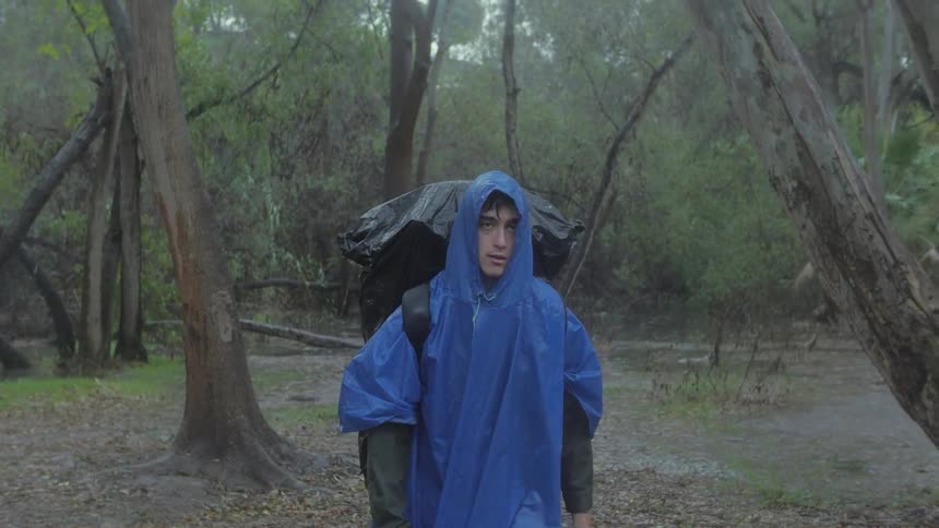 Man walking in the rain in a forest