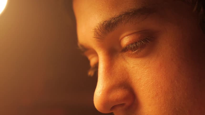 Man looking down at something in a room