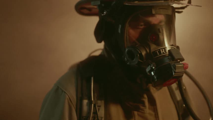 Firefighter looks on at a fire